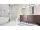 Luxurious bathroom featuring dual vanities, a soaking tub and a glass enclosed shower at 4201 N 18Th Pl, Phoenix, AZ 85016