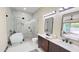 Bright bathroom with a free-standing tub, glass shower, and views of the outdoor pool area at 4201 N 18Th Pl, Phoenix, AZ 85016