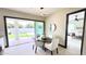 Dining area with a view of the backyard and pool through sliding glass doors at 4201 N 18Th Pl, Phoenix, AZ 85016