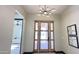 Spacious front entrance featuring modern light fixture, tiled floors, and views into bedroom at 4201 N 18Th Pl, Phoenix, AZ 85016