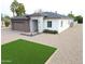 Stylish single-story home featuring a neutral color palette, manicured gravel yard and brick driveway at 4201 N 18Th Pl, Phoenix, AZ 85016