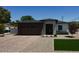 Modern single-story home boasts a stylish exterior with brick driveway, stone accents, and a two-car garage at 4201 N 18Th Pl, Phoenix, AZ 85016