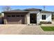 Stunning home showcasing a two-car garage, desert landscaping, and a modern, light-filled entryway at 4201 N 18Th Pl, Phoenix, AZ 85016