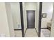 Hallway view features dark trim, wood-look tile flooring, and utility room access at 4201 N 18Th Pl, Phoenix, AZ 85016