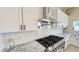 Close up of a modern kitchen featuring stainless steel appliances, white cabinets, and a tile backsplash at 4201 N 18Th Pl, Phoenix, AZ 85016