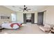 Spacious main bedroom with wood-look floors, ceiling fan, and barn door to the ensuite bathroom at 4201 N 18Th Pl, Phoenix, AZ 85016