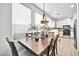 Bright dining area with wood table and chairs, adjacent to kitchen at 42424 N Gavilan Peak Pkwy # 47102, Anthem, AZ 85086