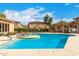 Community pool with lounge chairs and surrounding landscaping at 42424 N Gavilan Peak Pkwy # 47102, Anthem, AZ 85086