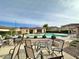 Community pool with patio seating and adjacent buildings at 42424 N Gavilan Peak Pkwy # 47102, Anthem, AZ 85086