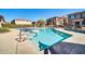 Community pool with surrounding patio furniture and seating at 42424 N Gavilan Peak Pkwy # 47102, Anthem, AZ 85086