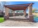 Covered patio with pergola, adjacent to a refreshing pool and spa at 44020 N 50Th Ln, New River, AZ 85087