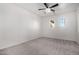 Well-lit bedroom with ceiling fan and carpet at 44020 N 50Th Ln, New River, AZ 85087