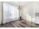 Bright dining room with hardwood floors and large window at 44020 N 50Th Ln, New River, AZ 85087