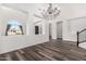 Elegant dining room features a chandelier and hardwood floors at 44020 N 50Th Ln, New River, AZ 85087