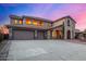 Two-story house with stucco exterior, three-car garage, and long driveway at 44020 N 50Th Ln, New River, AZ 85087