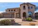 Two-story house with stucco exterior, three-car garage, and landscaped front yard at 44020 N 50Th Ln, New River, AZ 85087