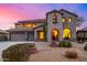 Two-story house with stucco exterior, three-car garage, and landscaped front yard at 44020 N 50Th Ln, New River, AZ 85087