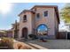 Two-story house with stone and stucco exterior, arched entryway, and attached three-car garage at 44020 N 50Th Ln, New River, AZ 85087