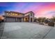 Two-story house with stucco exterior, three-car garage, and long driveway at 44020 N 50Th Ln, New River, AZ 85087