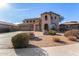 Two-story house with stucco exterior, three-car garage, and landscaped front yard at 44020 N 50Th Ln, New River, AZ 85087