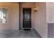 Dark brown front door with sidelights and a small porch at 44020 N 50Th Ln, New River, AZ 85087