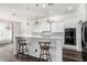 Bright kitchen with white cabinets, quartz countertops, and island at 44020 N 50Th Ln, New River, AZ 85087