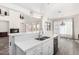 Modern kitchen island with white cabinets and quartz countertops at 44020 N 50Th Ln, New River, AZ 85087