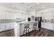 Modern kitchen with white cabinets and breakfast bar at 44020 N 50Th Ln, New River, AZ 85087