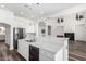 Spacious kitchen with island, white cabinets, and stainless steel appliances at 44020 N 50Th Ln, New River, AZ 85087