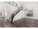 Elegant staircase with wrought iron railing and crystal chandelier at 44020 N 50Th Ln, New River, AZ 85087