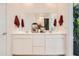 Double vanity bathroom with white cabinets and a large mirror at 4526 E Danta St, San Tan Valley, AZ 85143