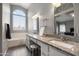 Bright bathroom with dual sinks, granite countertops, modern lighting fixtures and large arched window at 4760 W Tulsa St, Chandler, AZ 85226