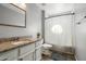 Well-lit bathroom featuring a granite countertop vanity, toilet, and a shower with patterned curtain at 4760 W Tulsa St, Chandler, AZ 85226