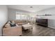 Bright living room featuring modern wood-look floors and large windows with plantation shutters at 4760 W Tulsa St, Chandler, AZ 85226