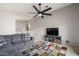 Comfortable living room features ceiling fan, cozy sofa, colorful rug and sleek TV on rustic wood cabinet at 4760 W Tulsa St, Chandler, AZ 85226