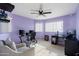 Bright home office with purple walls, ceiling fan, modern desk, and comfortable armchair at 4760 W Tulsa St, Chandler, AZ 85226