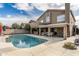 Backyard pool with a diving board, with a covered patio and hot tub at 4760 W Tulsa St, Chandler, AZ 85226