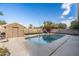 Backyard pool with a diving board, shed, lounge chairs and grass at 4760 W Tulsa St, Chandler, AZ 85226