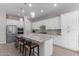 Modern kitchen with white cabinets, gray countertops, and an island with seating at 4765 S Pluto --, Mesa, AZ 85212