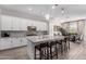 Modern kitchen with white cabinets, gray countertops, and an island with seating at 4765 S Pluto --, Mesa, AZ 85212