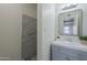 Clean bathroom with gray vanity, marble shower, and mirror at 5115 N 22Nd Ave # 1, Phoenix, AZ 85015