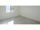 Bright bedroom with light wood-look flooring and window at 5115 N 22Nd Ave # 1, Phoenix, AZ 85015