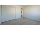 Simple bedroom with light walls, wood-look floors, and double door closet at 5115 N 22Nd Ave # 1, Phoenix, AZ 85015