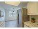 Modern kitchen with stainless steel refrigerator and light flooring at 5115 N 22Nd Ave # 1, Phoenix, AZ 85015