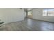 Open living room with gray laminate floors and a fireplace at 5115 N 22Nd Ave # 1, Phoenix, AZ 85015