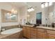 Large bathroom with double vanity, soaking tub, and glass shower at 5133 N 34Th Pl, Phoenix, AZ 85018