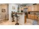 Kitchen features a breakfast bar, stainless steel appliances, and light wood cabinets at 5133 N 34Th Pl, Phoenix, AZ 85018