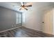 Bedroom with wood-look floors, ceiling fan, and window shutters at 5172 E Desert Forest Trl, Cave Creek, AZ 85331