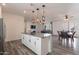 Modern kitchen with white cabinets, granite island, and stainless steel appliances at 5172 E Desert Forest Trl, Cave Creek, AZ 85331