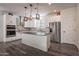 Modern kitchen with white cabinets, granite island, and stainless steel appliances at 5172 E Desert Forest Trl, Cave Creek, AZ 85331